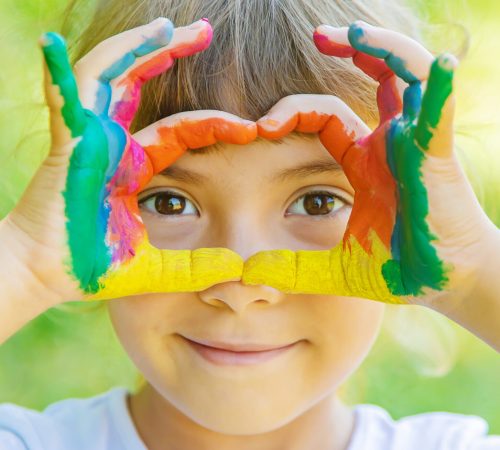 child with painted hands and legs. Selective focus.